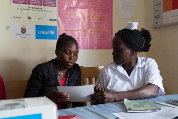 A pregnant woman registers during her antenatal care visit at a health centre Uganda