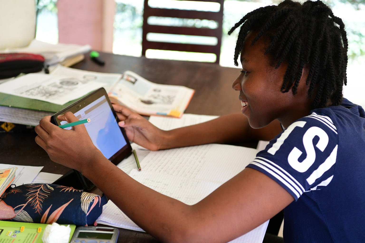 adolescents using a tablet for class