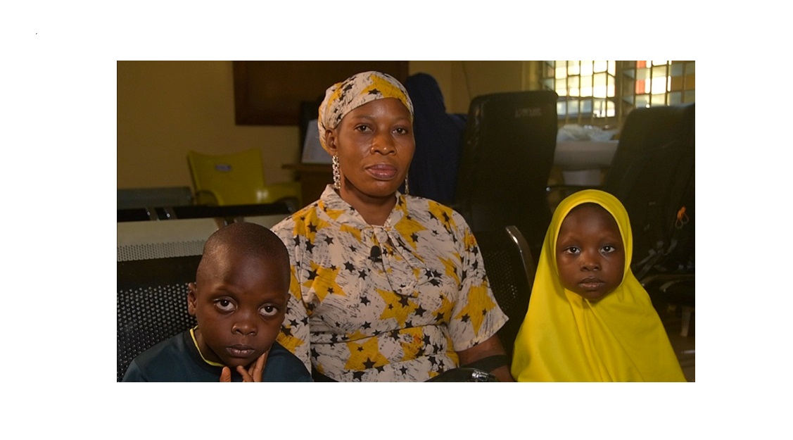 A mother, and beneficiary of the CDC-Nigeria PMTCT program, poses for a picture with her HIV-negative twins