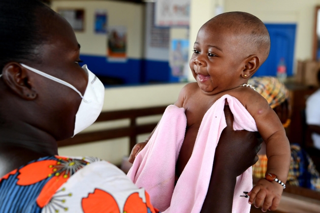 3 months old baby waiting to be weighted and vaccinated in a health center in Cote D'Ivoire