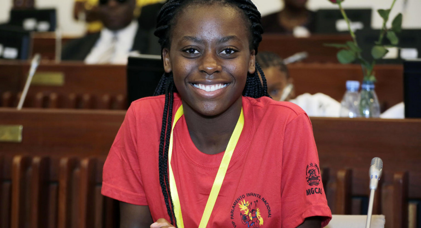 Young women smiling and wearing a meda