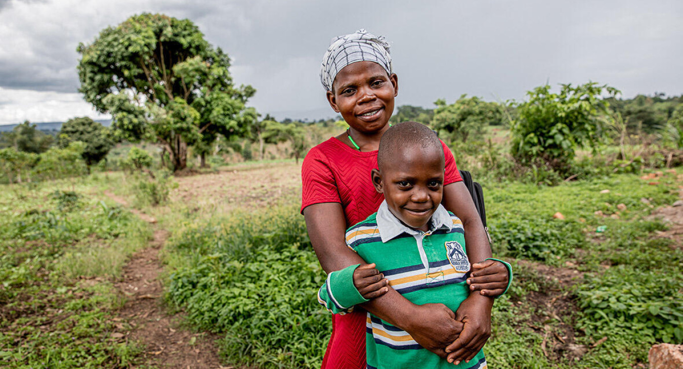 Mother hugging a child in a filed