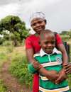 Margret and her son Ronald, age 9, on their way to an HIV clinic for a health screening in Mubende, Uganda.