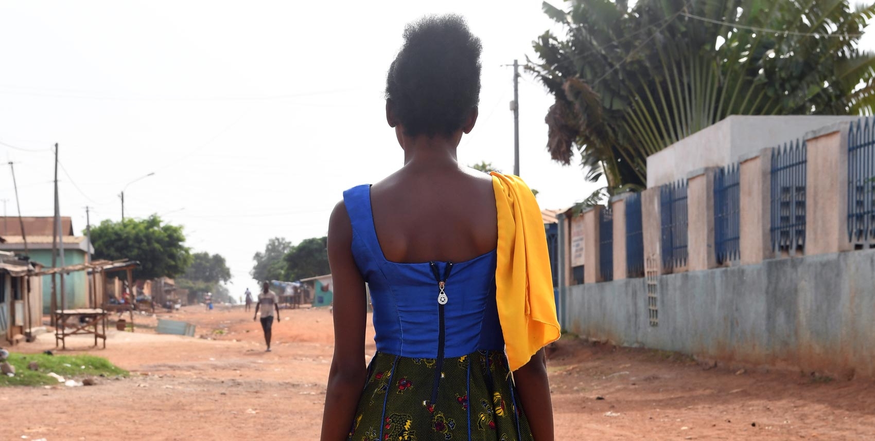 A young woman stands back to camera